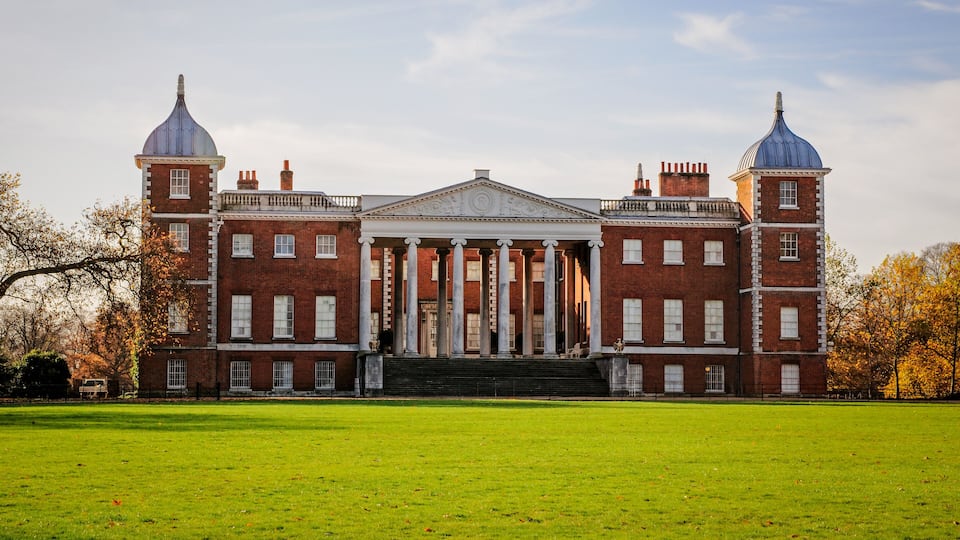 A large brick building with a central portico and two towers.