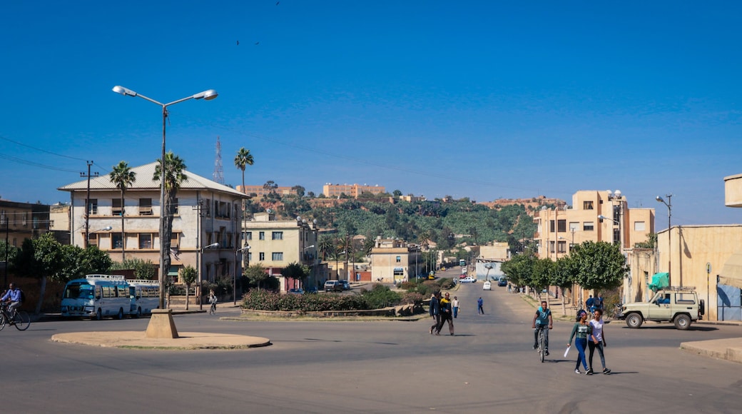 Asmara, Eritrea - November 01, 2019: Old Buildings and Cars around of Local Market