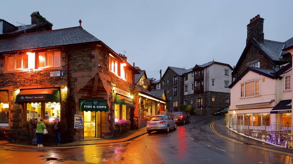 A wet street in a town with shops like 'The Walnut Fish & Chips' and 'Fino'.