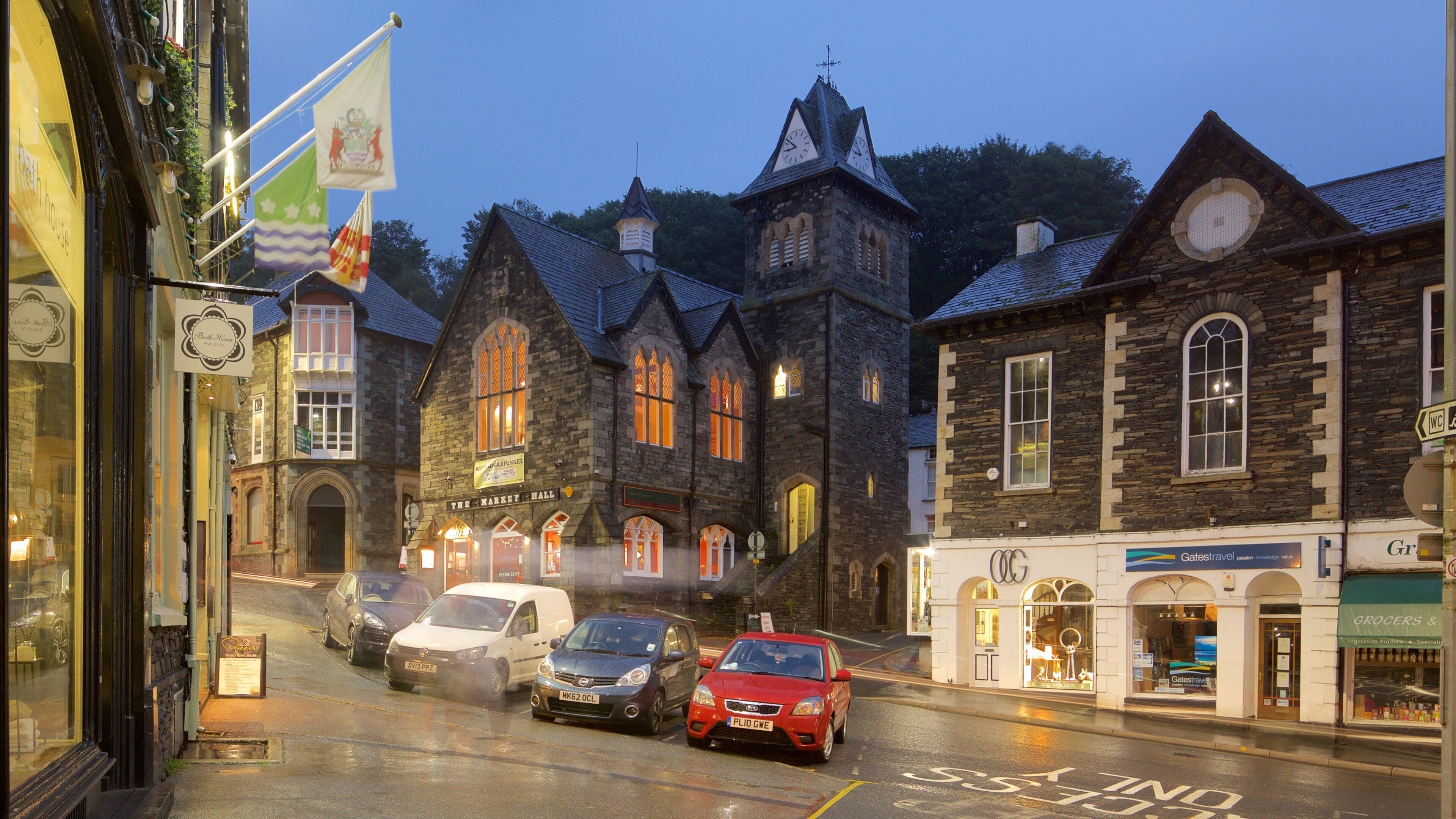 A historic street with stone buildings, a pub named 'The Waverly Hall', and a 'Gates Travel' store.