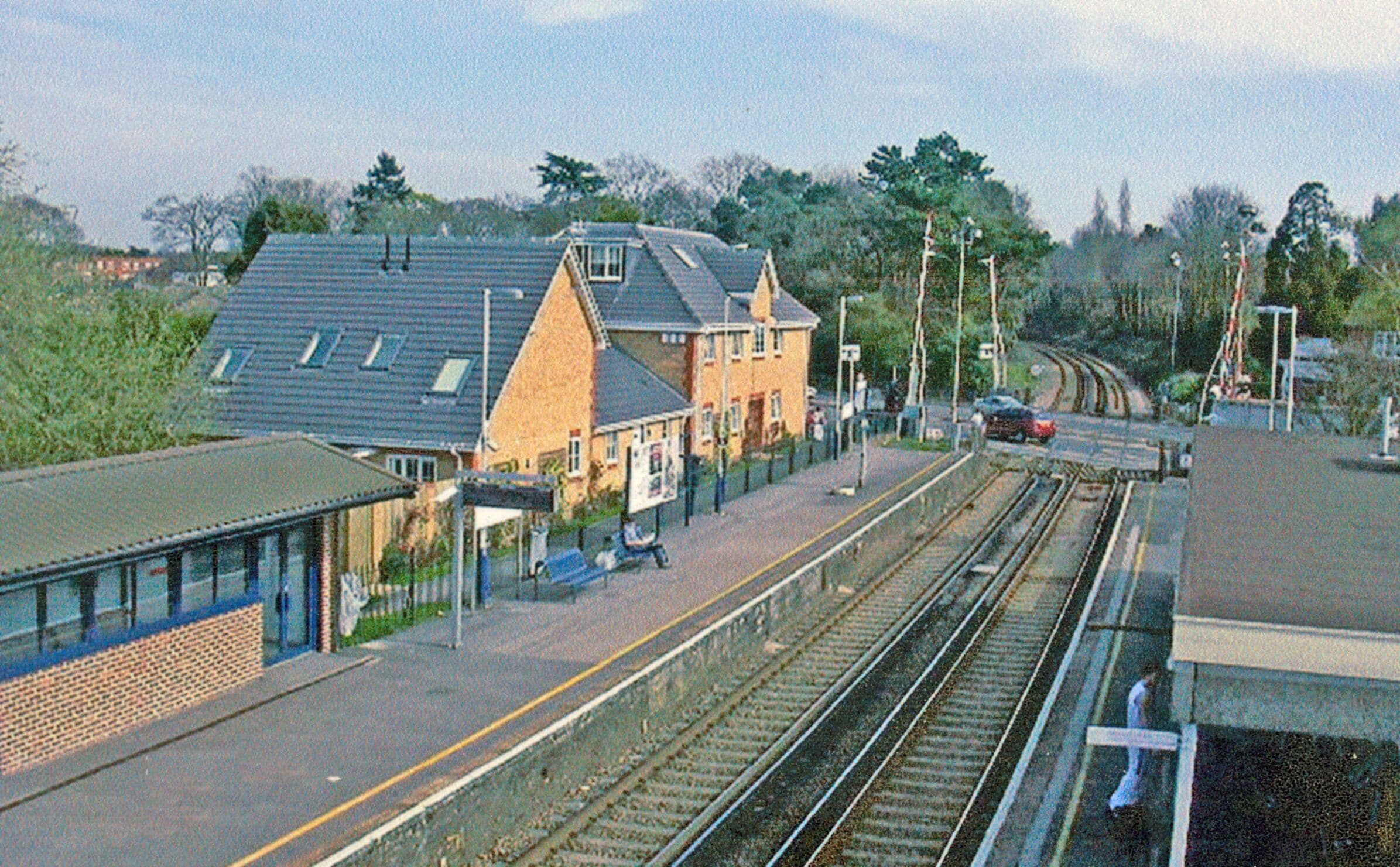 Sunningdale Station. View SE across A30 level-crossing, towards Virginia Water, Staines and London Waterloo: ex-LSWR London - Staines - Ascot - Reading line.