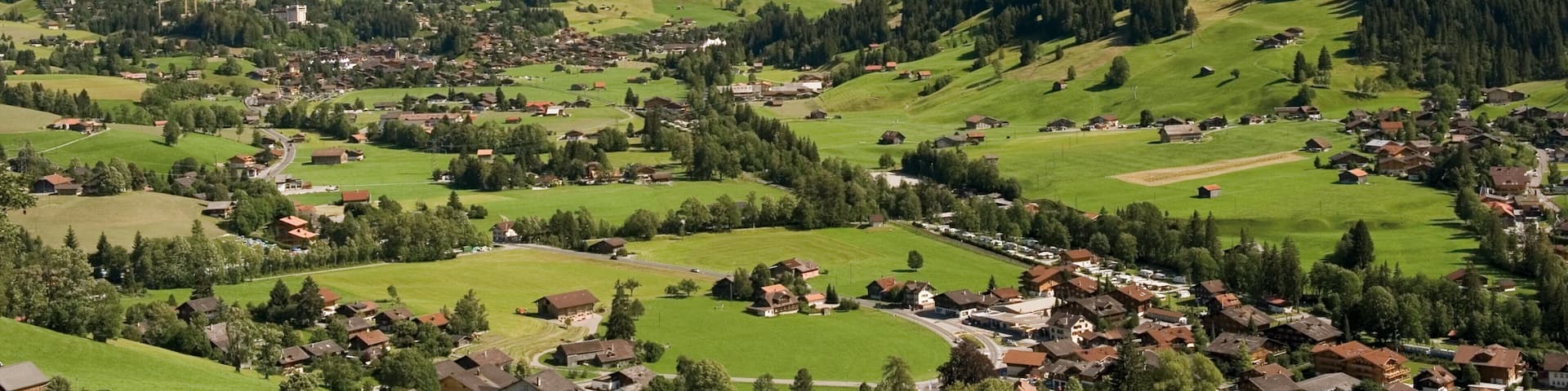 Gstaad which includes tranquil scenes, mountains and a small town or village