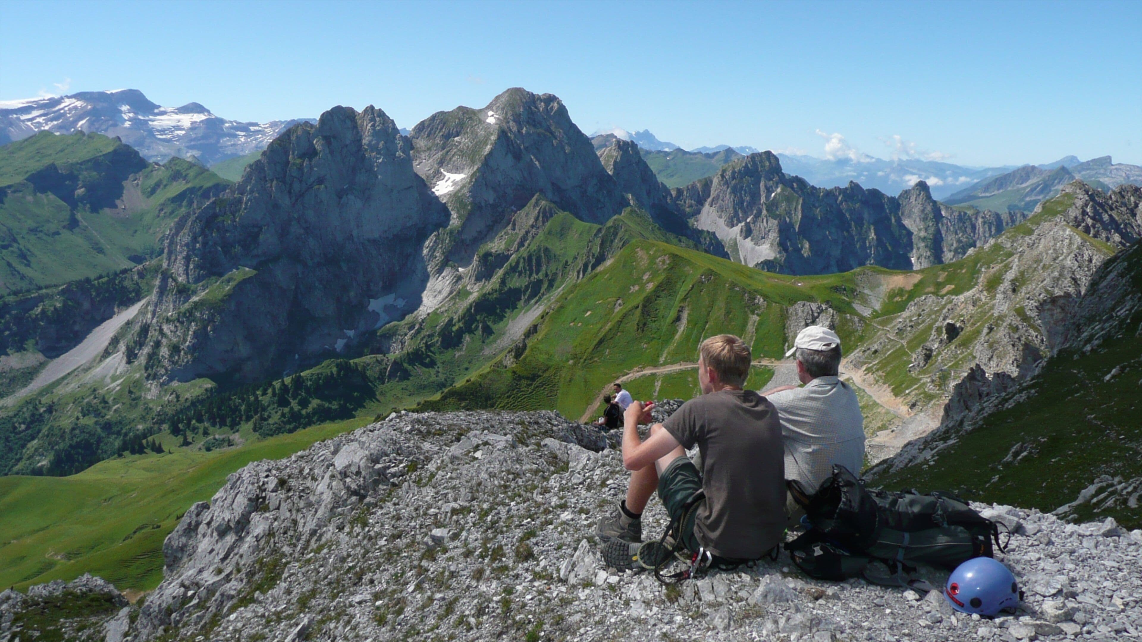 Gstaad which includes a gorge or canyon and mountains as well as a small group of people