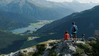 A mountainous landscape with a lake and a town in the valley.