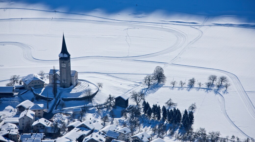 Laax which includes a small town or village, landscape views and snow
