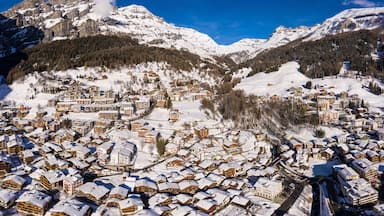 Stunning aerial panorama of the Leukerbad village at the bottom of the Gemmi pass in Canton Valais in the alps in Switzerland on a sunny winter day.