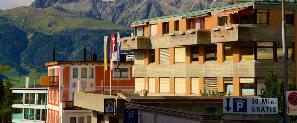 A building with a mountain range in the background.