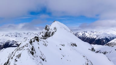 A snow-covered mountain range with rugged peaks and valleys.