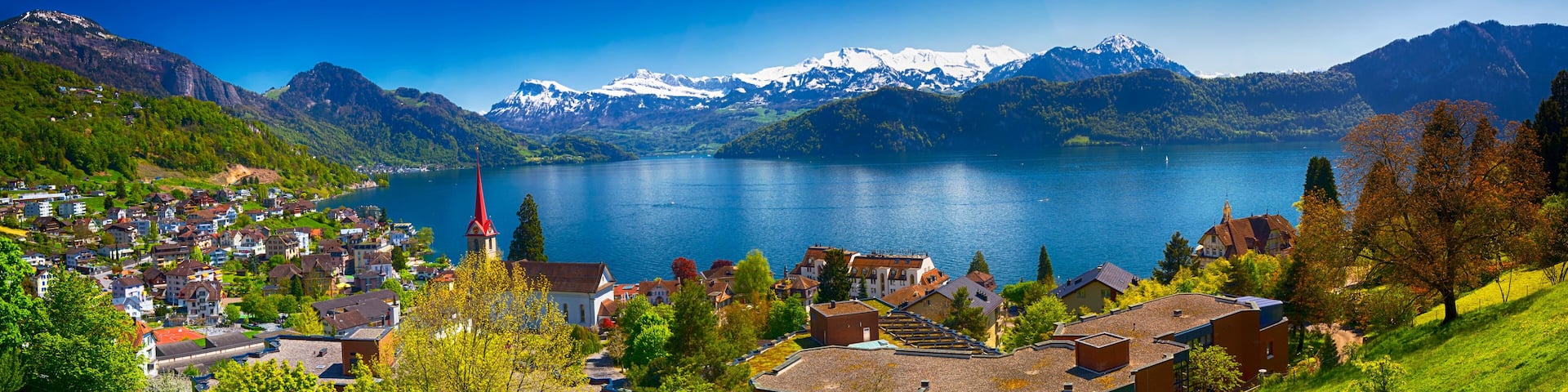 Panorama image of village Weggis, lake Lucerne (Vierwaldstatersee), Pilatus mountain and Swiss Alps in the background near famous Lucerne (Luzern) city, Switzerland