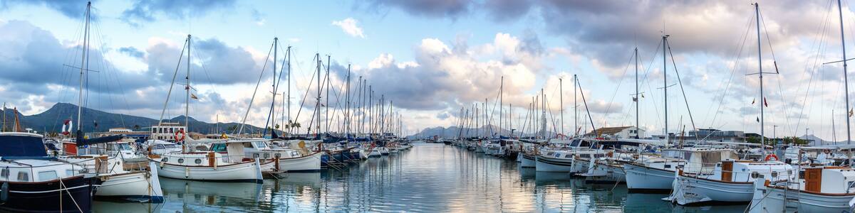 Port de Pollenca marina with sailing boats sailboats on Mallorca travel traveling holidays vacation panorama in Spain