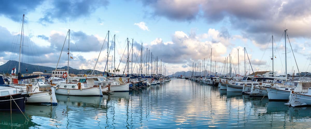 Port de Pollenca marina with sailing boats sailboats on Mallorca travel traveling holidays vacation panorama in Spain