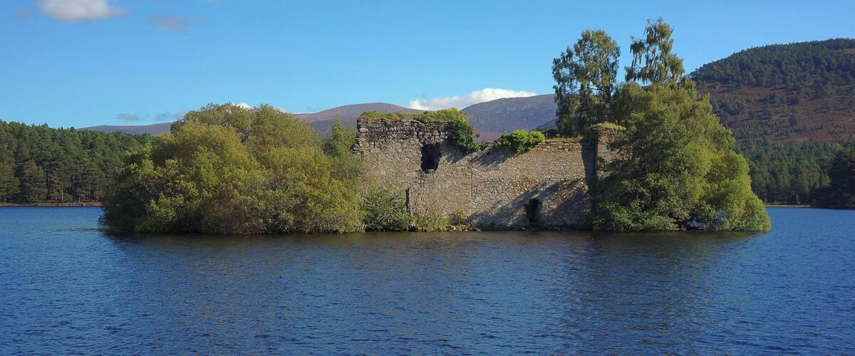 Loch an Eilein Castle in the Scottish Highlands from the shore of Loch an Eilein