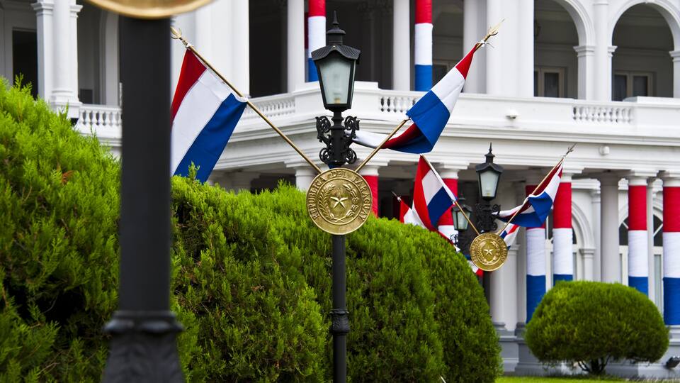 A building with columns and flags.