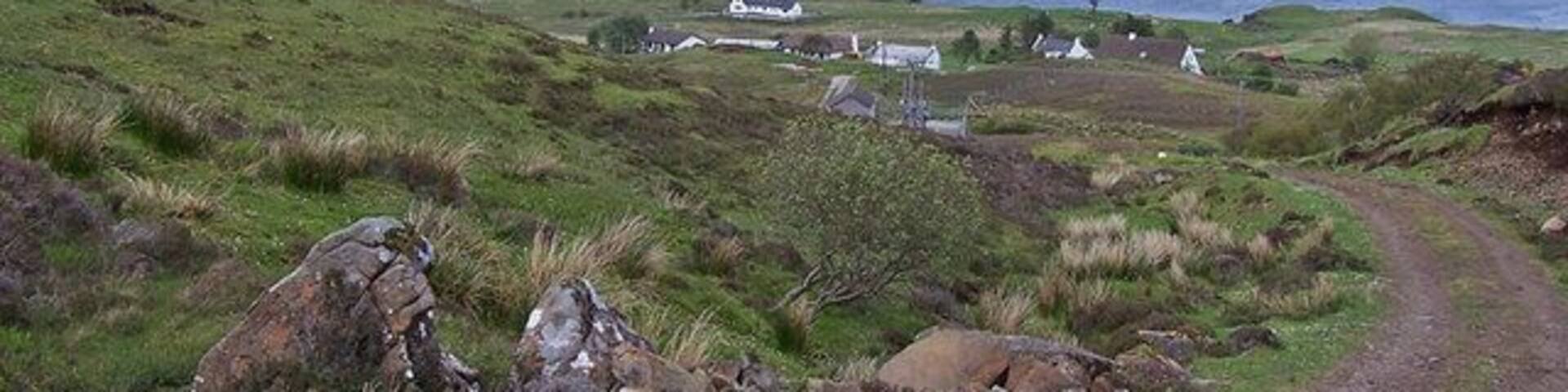 Track towards Lower Ollach The track provides access to the Braes water treatment plant. At the top of the track is a viewpoint at Farquhar's seat, above the Coille Iosal woodland. Beyond, the mountain is Ben Tianaviag.