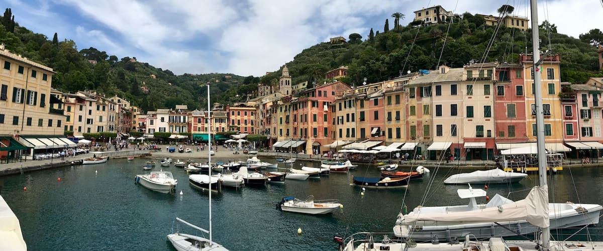 A marina with colorful buildings and boats docked.