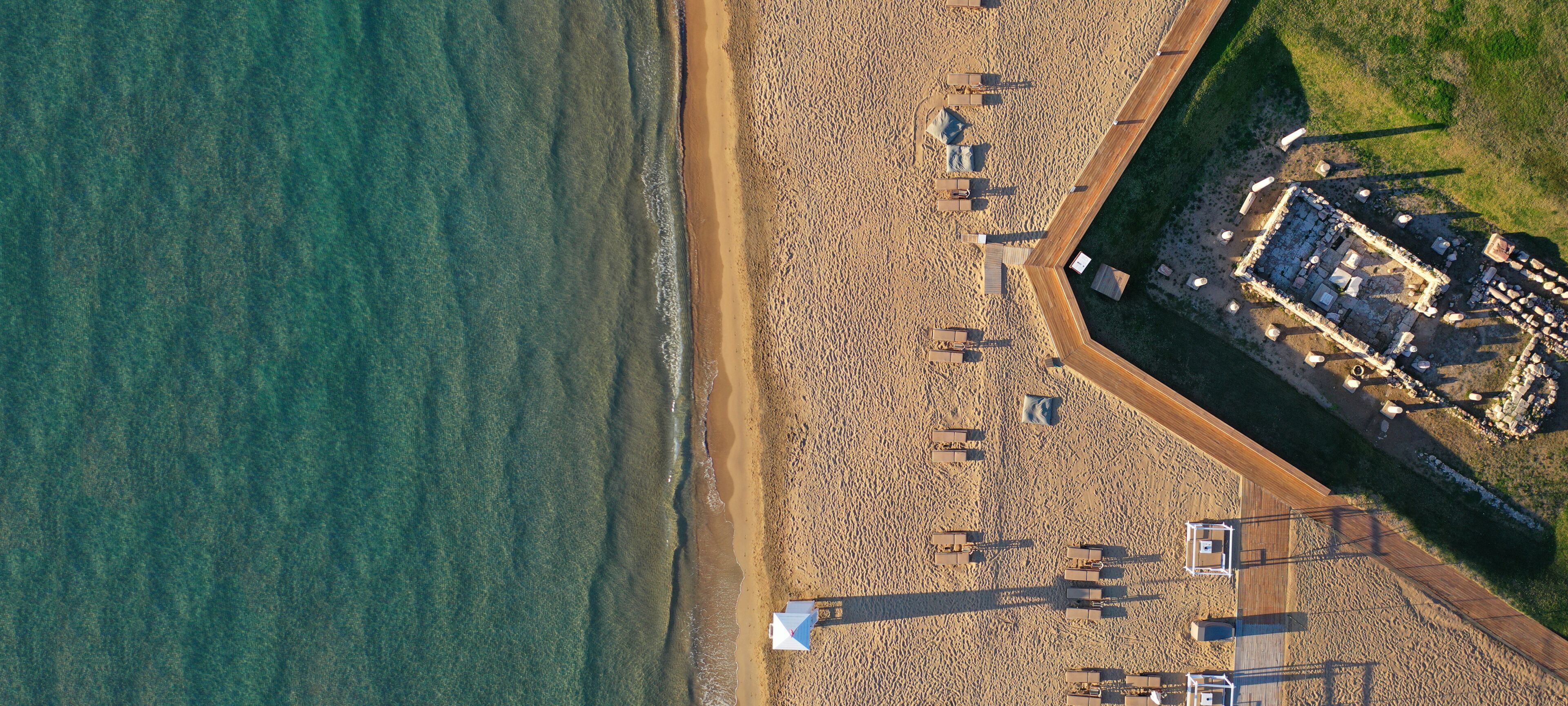 Aerial drone ultra wide top down photo of famous sandy beach of Asteras or Astir in Vouliagmeni, Glyfada, Athens riviera, Attica, Greece