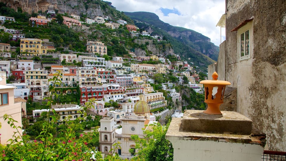 A coastal town with colorful buildings nestled against a steep hillside.