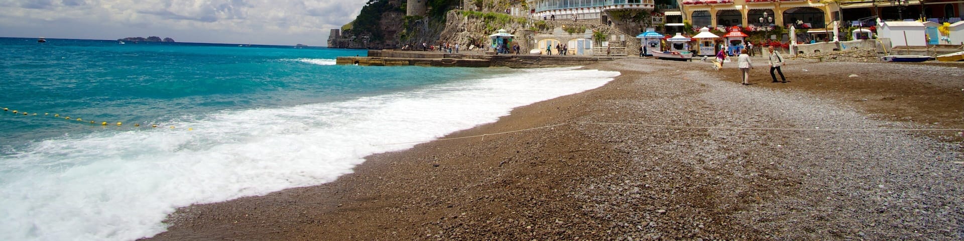 Positano which includes a beach and a coastal town