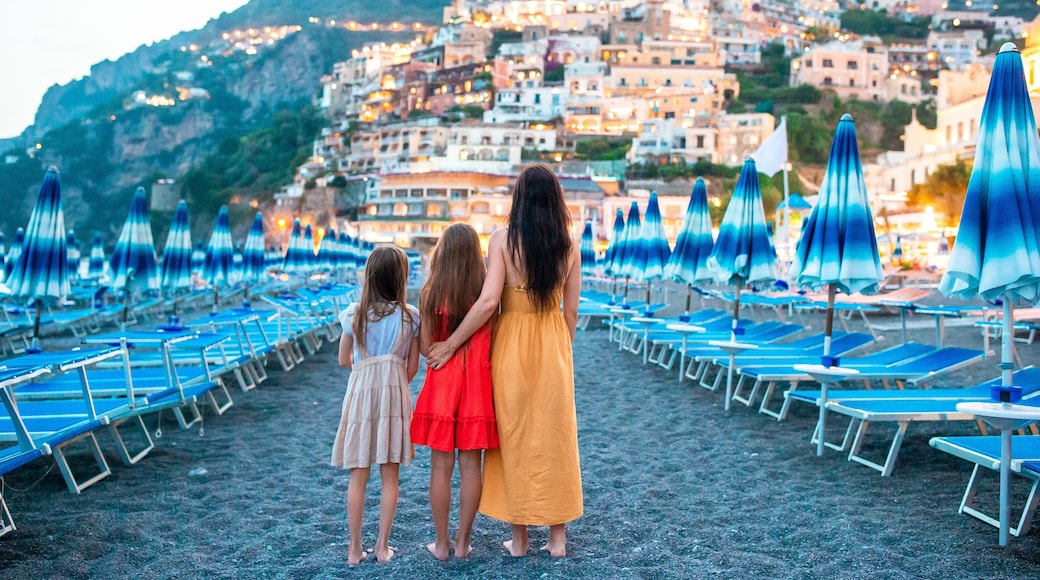 Family in front of Positano on the Amalfi coast in Italy in sunset