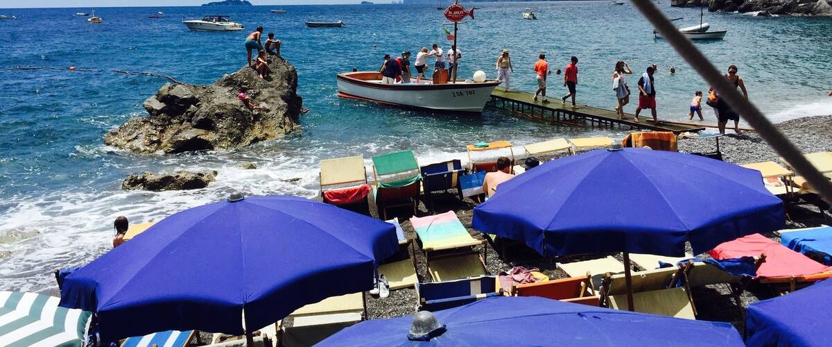 Laid back beach club and restaurant accessible by water taxi from positano.  Nice swimming for kids.  One of the best lunches I've ever had: mussel soup, homemade spaghetti with pesto, marinated anchovies.  And don't forget the chilled peach  wine!  Come for a great day.