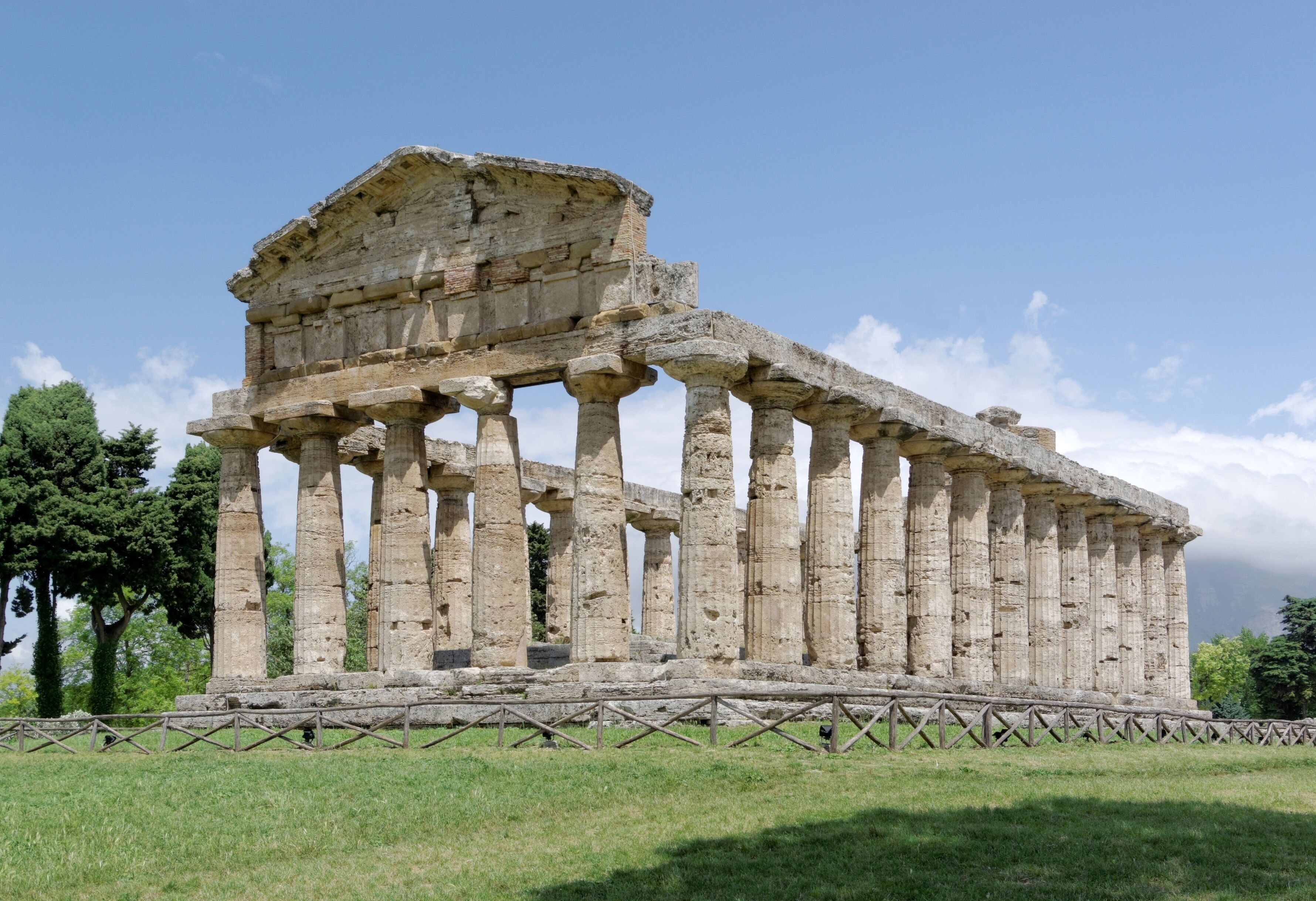 An ancient Greek temple with Doric columns and a partially intact pediment.