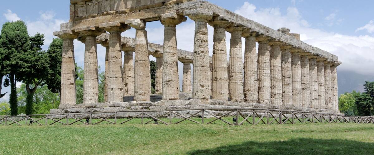 An ancient Greek temple with Doric columns and a partially intact pediment.