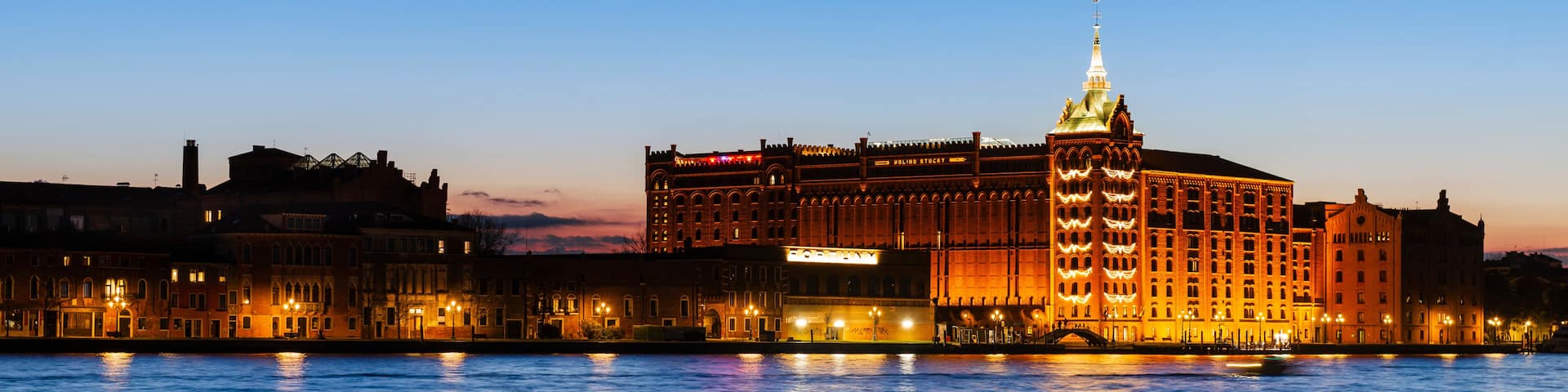 Molino Stucky building with hotel along Giudecca Canal in St Mark's basin; Venice, Veneto, Italy