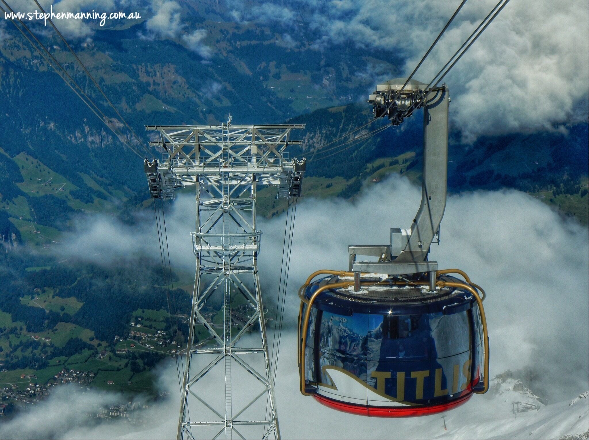 A cable car system with a mountainous landscape in the background.