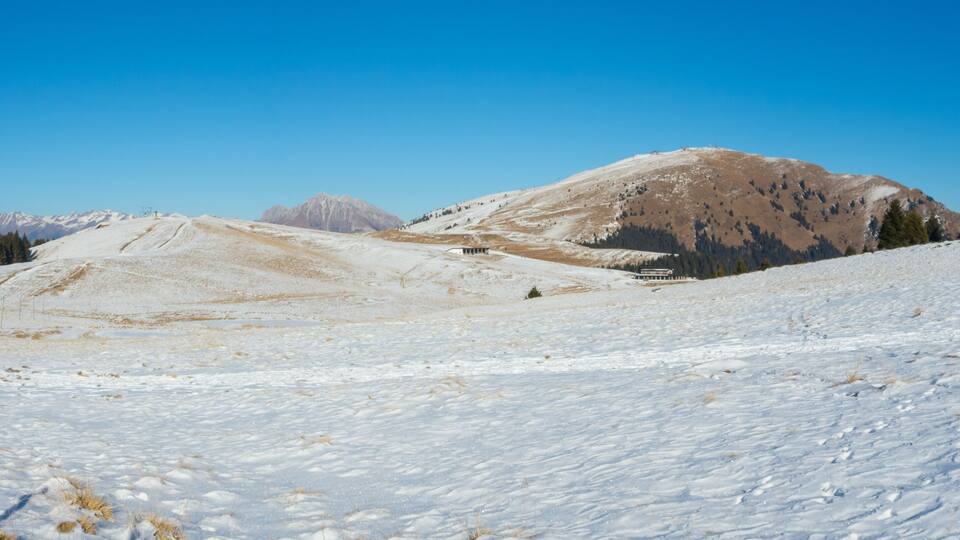 A snow-covered mountain landscape with a clear sky.