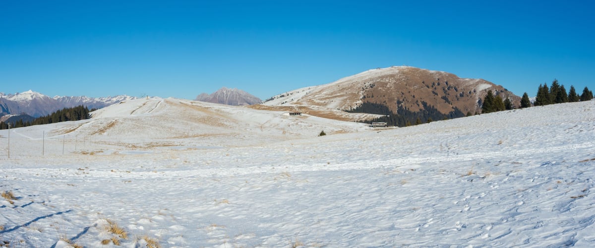 A snow-covered mountain landscape with a clear sky.