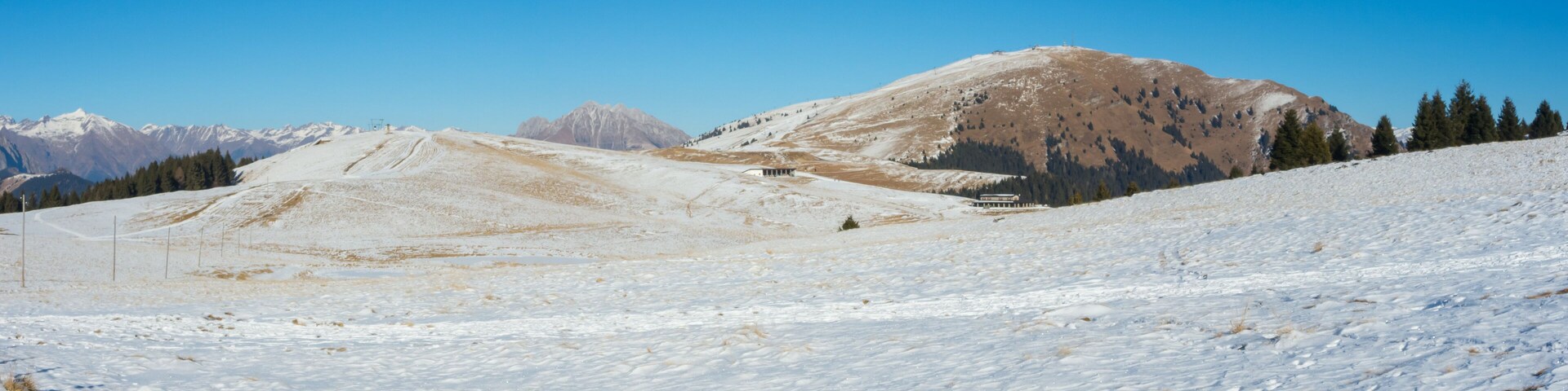 A snow-covered mountain landscape with a clear sky.