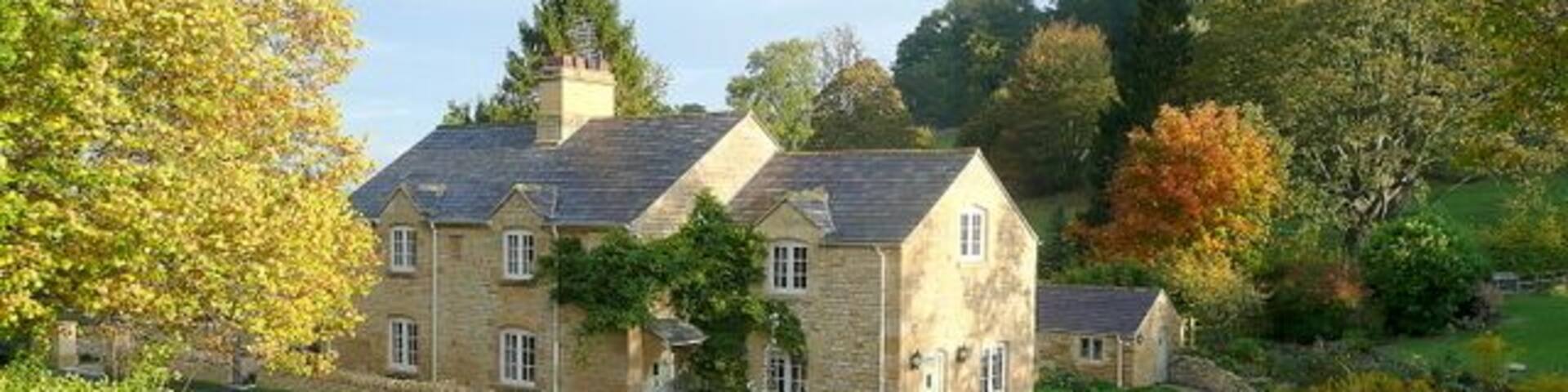 Cottage in Buckland A fine dwelling viewed from the elevated churchyard of St. Michael's church to the south.