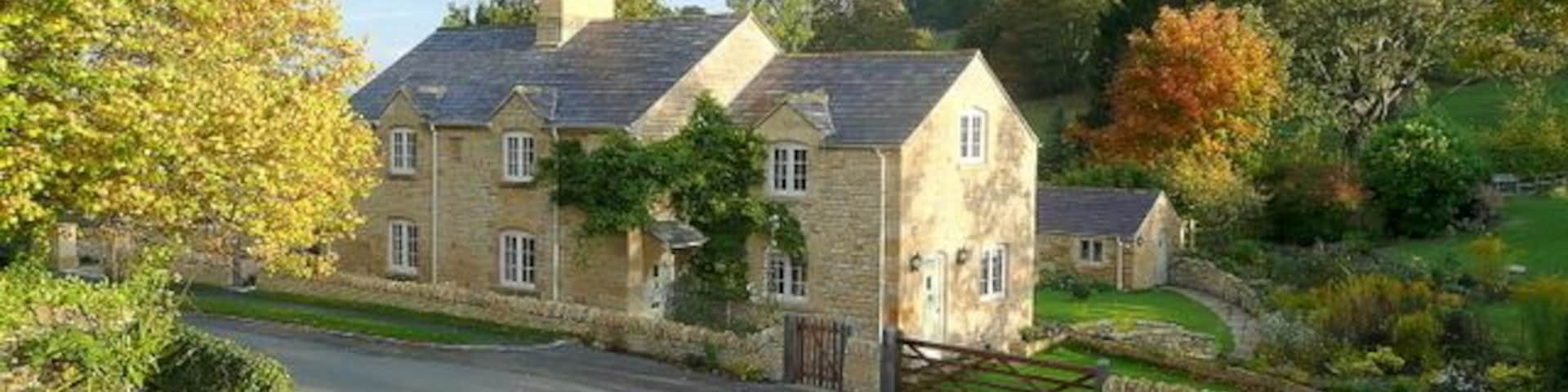 Cottage in Buckland A fine dwelling viewed from the elevated churchyard of St. Michael's church to the south.