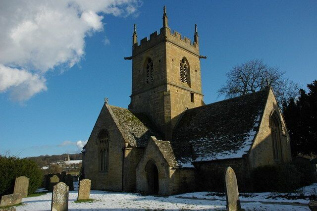 A church with a tall tower and a snow-covered roof.