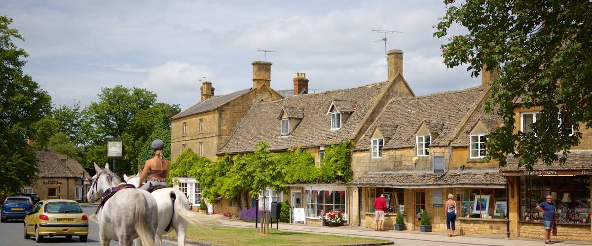 Broadway which includes a small town or village, street scenes and horse riding