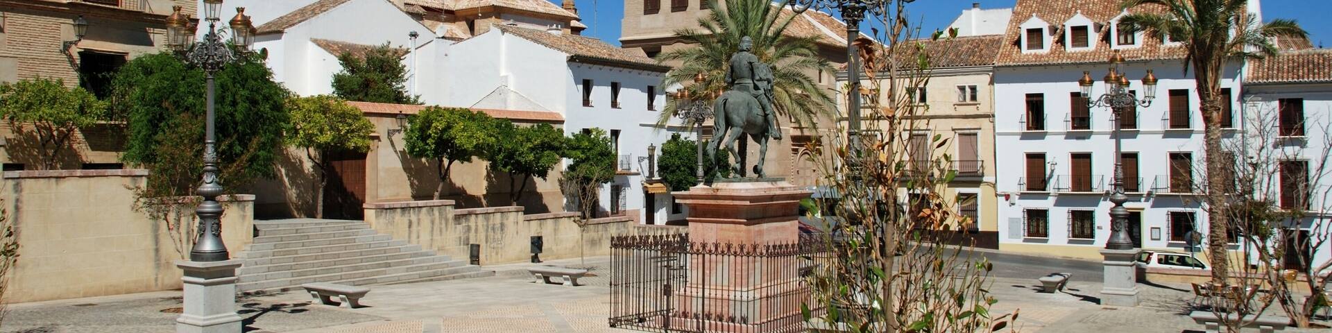 View along the main shopping street with the church to the rear, Torrox, Costa del Sol, Malaga Province, Andalusia, Spain, Western Europe.