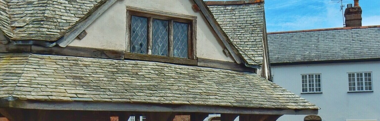 The Duster Yarn Market in Somerset, England is a 17th century octagonal timber framed covered market hall. It was built for the sale of local broadcloth and homespuns in 1607 by George Luttrell of Dunster Castle. This four hundred year old building is managed by the National Trust and sits proudly in the middle of Dunster's high street. Enjoy a cup of tea, warm scone with jam and cream in one of the many small tea rooms which line the street. #market