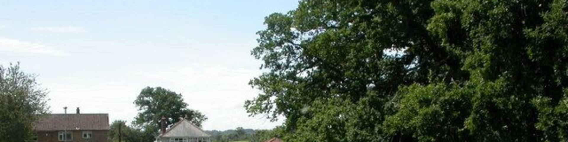 West Parley, footpath. The Southern end of a path from Christchurch Road to 1422064. On the other side of Christchurch Road, Dudsbury Golf Club.