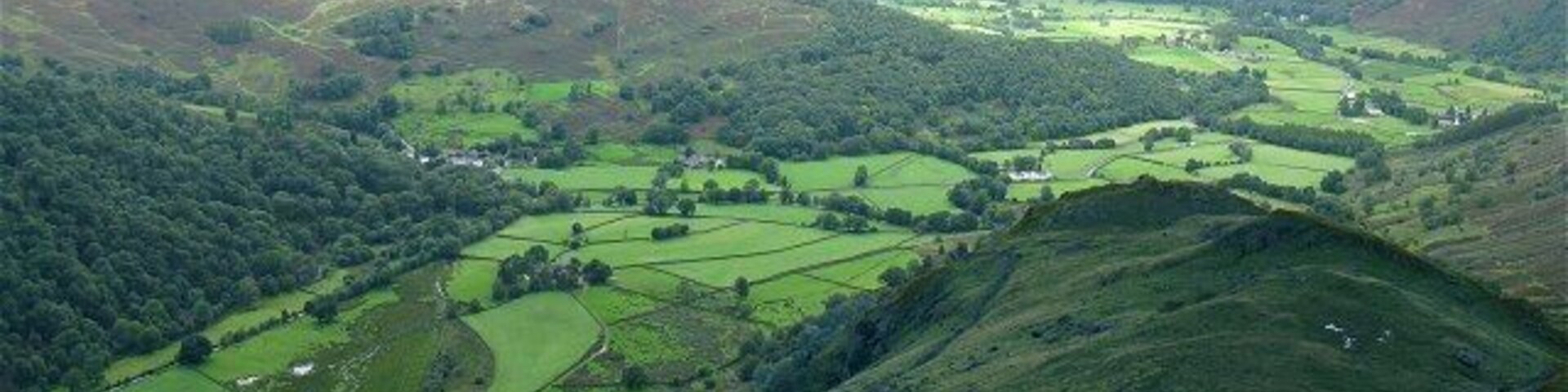 Looking down Thornythwaite Fell A small break in the solid, low cloud base somehow lights up all the fields in Borrowdale with a luminous glow.