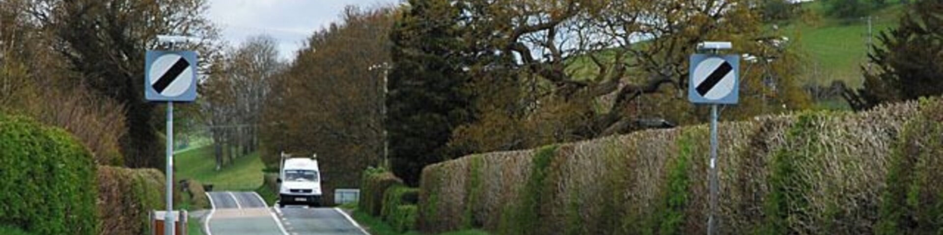 The A489 exits east from Penegoes