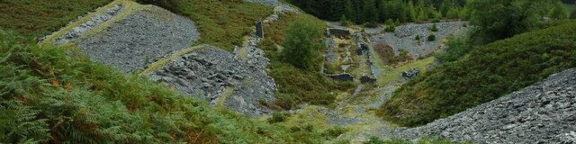 Remains of a quarry above Dinas Mawddwy Discarded slate and the remains of a building at a disused quarry above Dinas Mawddwy.