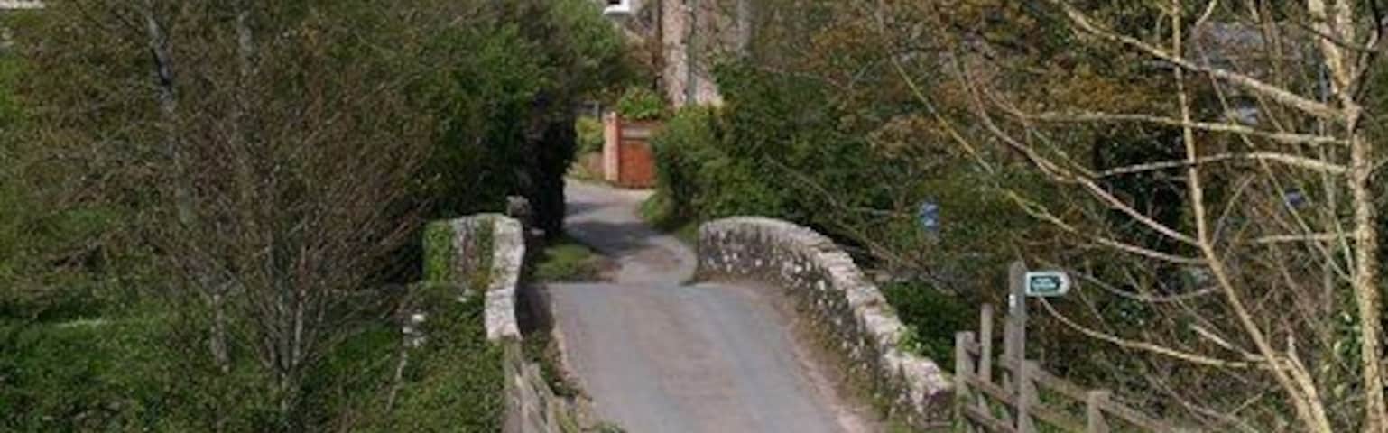 Loddiswell Mill Bridge. Seen from close to the lane junction shown in 1296747. The bridge crosses the River Avon. Beyond is Avon Mill House.