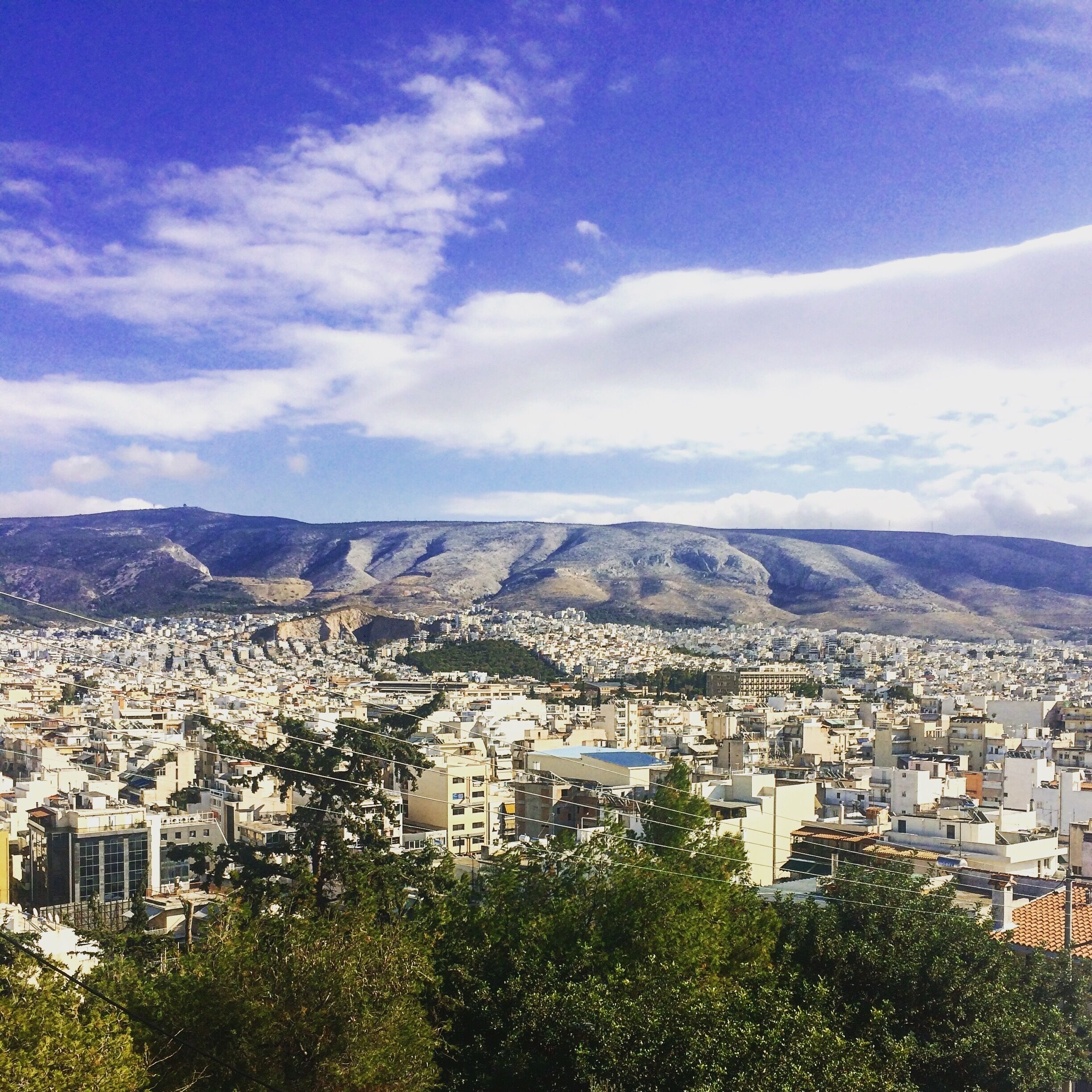 A cityscape with mountains in the background.