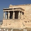 A classical Greek temple with Doric columns and a partially intact pediment.