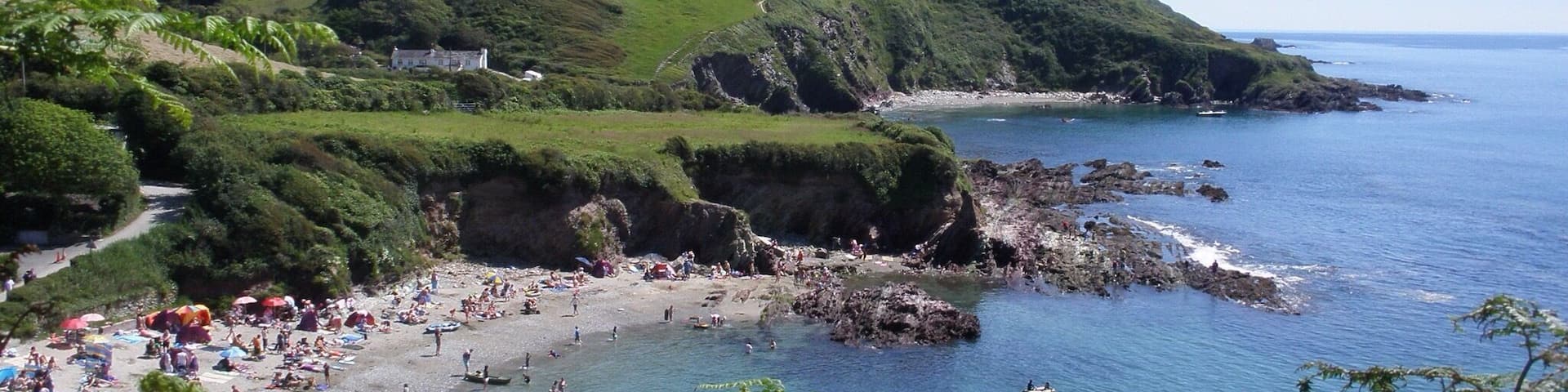 Talland Bay is a lovely cove , it has a little beach cafe , with a car park - so ideal when you have all your beach gear .
This photo was taken from the costal path - Talland Bay to Polperro , this walk is a must as the views are amazing.
