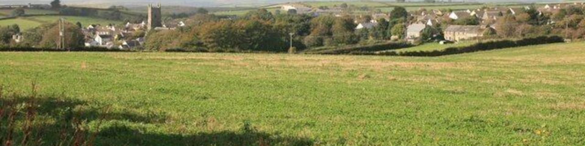 Pelynt in the distance As seen from the gateway by Becons trig point, Pelynt churchtower is in the middle of the village with Hall Barton farm on the right.