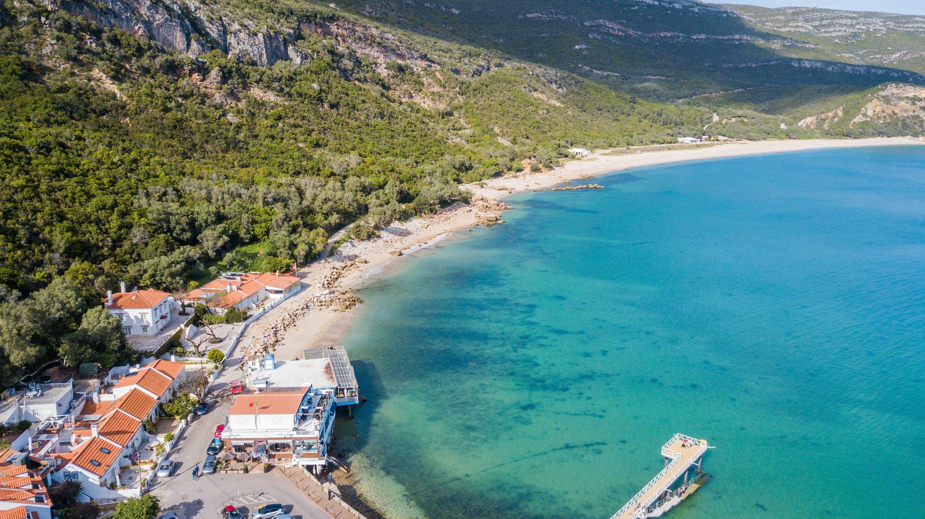 Aerial view of Portinho da Arrábida beach, in Setúbal, Portugal. Transparent water beach