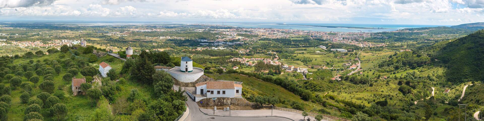 Stunning view from the castle Palmela with beautiful clouds in the sky and the city of Setuball in the background. Portugal
