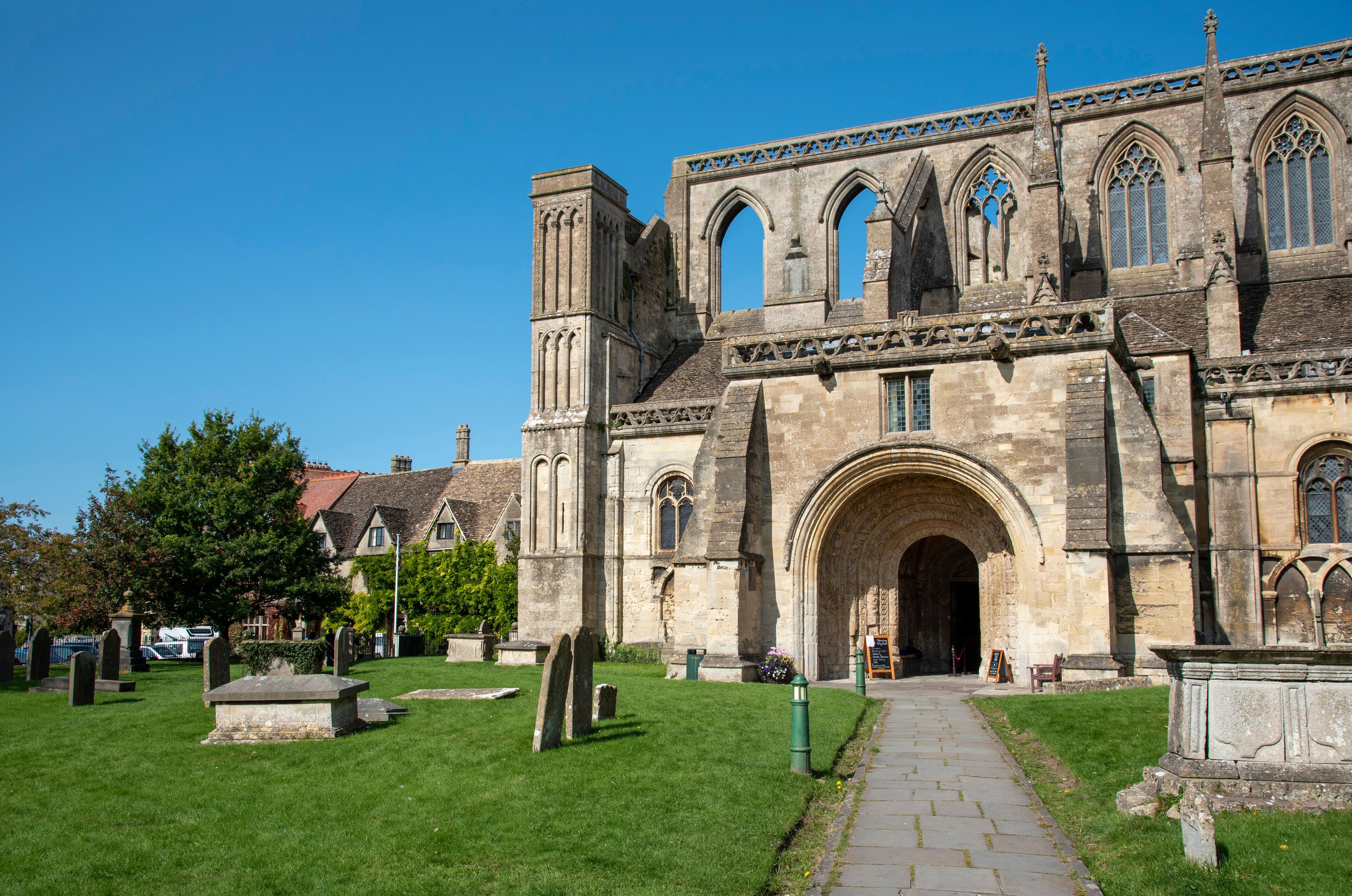 Malmesbury, Wiltshire, England, UK. 2020. The exterior of the 12th century Malmesbury Abbey and graveyard.