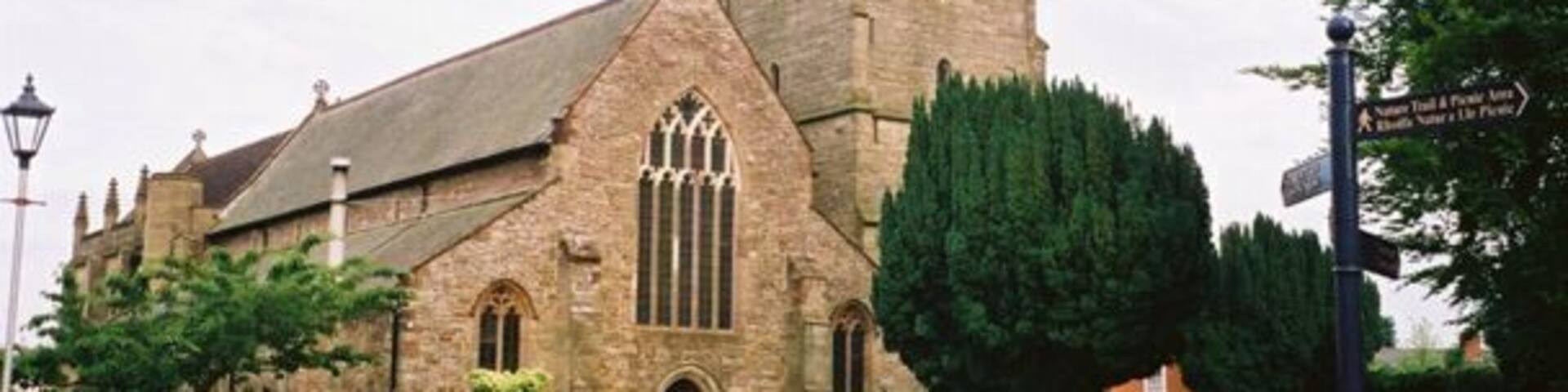 A historic church with a tall tower and arched windows.